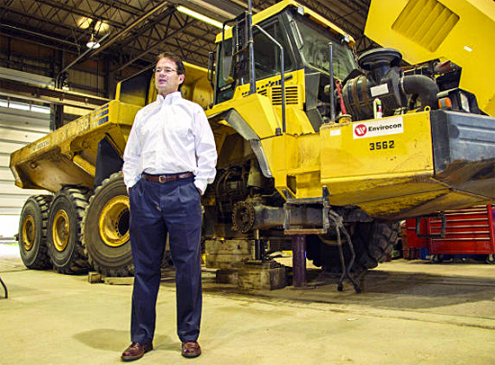 Brian Sheridan, Modern Machinery president, stands next to an articulated truck in Modern Machinery’s repair shop in Missoula last week. In addition to the bulldozers, Modern is currently working on shipping a dozen substantially larger 240-ton trucks to the gold mine project. The trucks have tires that are 12 feet in diameter.